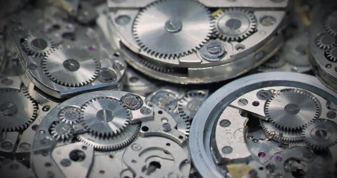 Old watches being disassembled. Metal parts of old mechanical watch in watch workshop. Disassembled mechanical wrist watch. Cinema 4K 60fps video