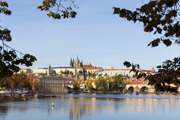 Autumn colorful Prague Lesser Town with gothic Castle above River Vltava in the sunny Day, Czech...