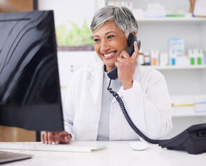 Pharmacist, telephone and computer for prescription with woman in conversation for retail...