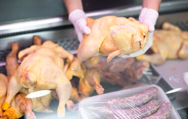 Inside refrigerated display, selection of poultry products is neatly presented.