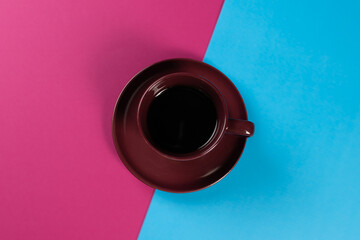 burgundy cup on a pink and blue background
