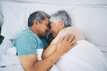 Foto op Canvas Top view, hug and senior couple in bed, relax and sleeping with happiness, quality time and loving together. Romance, old man or elderly woman embrace, bedroom and retirement with marriage and love © Sharne/peopleimages.com