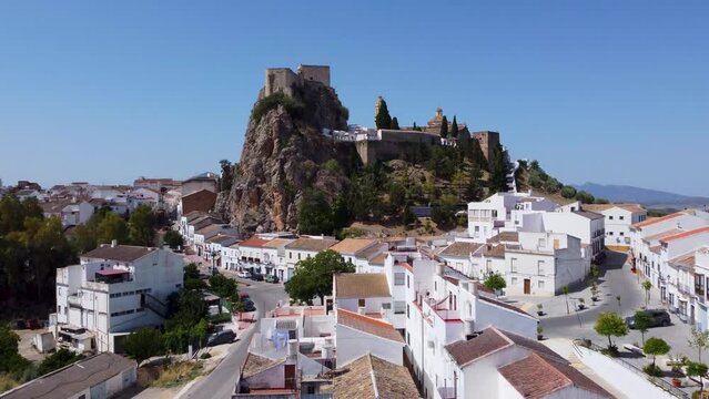 The small Spanish town of Olvera in Andalucia with white washed buildings, a hilltop castle and cathedral