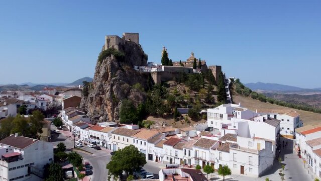 The small Spanish town of Olvera in Andalucia with white washed buildings, a hilltop castle and cathedral