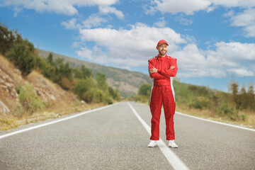 Obraz premium Racer in a red suit standing on the road