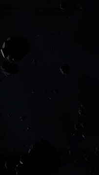 Asteroid belt field in dark outer space. 3D animation wide pan shot. Rock formations of cosmic debris and giant Meteorites. Celestial objects on starry stars background with dust nebula haze low light