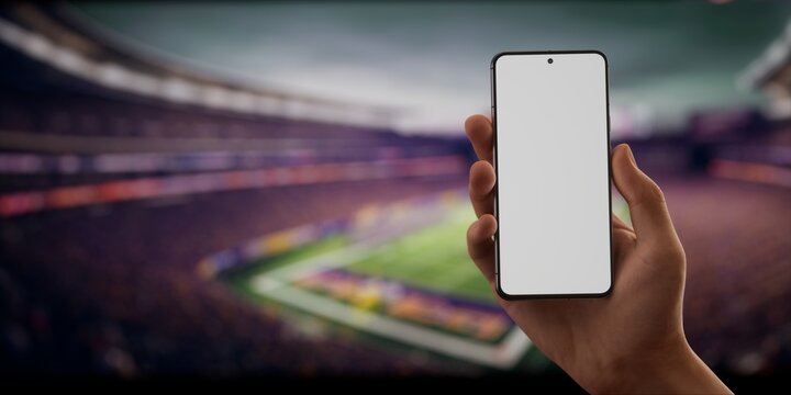 CU Caucasian man using his phone during American football game on a huge stadium