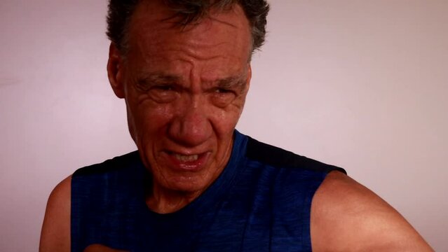 Slow Motion of an older man shadow boxing with no gloves and sweating