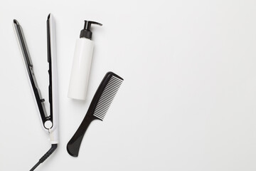 Hair straightener with thermo protection on color background, top, view