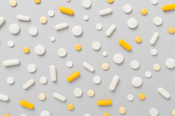 Flat lay with different medical pills and capsules on color background