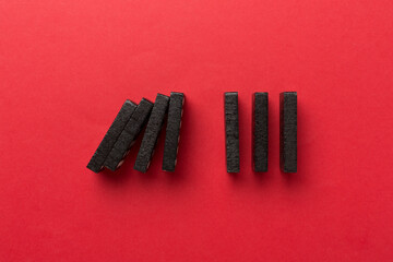 Black domino tiles on color background, top view