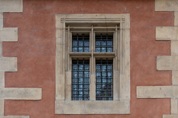 Detail of old window on the wall of an old building with lattice.