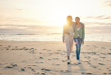 Love, beach and sunset, lesbian couple walking together on sand, sunset holiday adventure or hug on...
