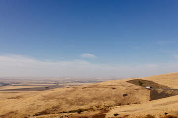Beautiful autumn landscape with meadows and a road from a bird's eye view. Nature in Oregon in fall. Panorama. Pendleton, Oregon, USA