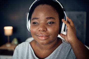 Crying, sad and black woman with headphones for music, sound or audio. Tears, radio and plus size...