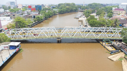 The KM 1 bridge is located in Banjarmasin which crosses over the Martapura river