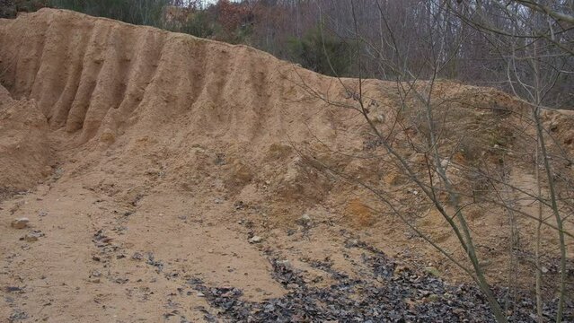 roundup on a deep gully in a slope of red clay