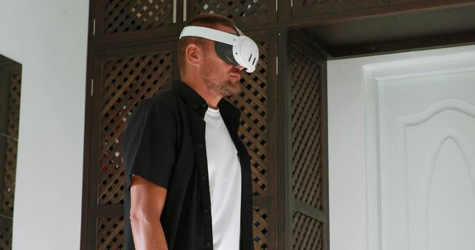 Man looking on mixed virtual reality world in vr goggles.