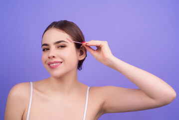 Beautiful woman with dark eyebrows hold eyebrow brush. Eyebrows lamination. Brow beauty procedures....