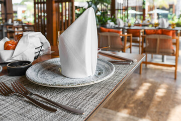 Dishware and cutlery on table in cafeteria, closeup