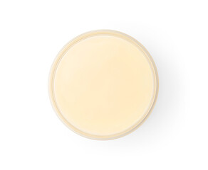 Bowl with condensed milk isolated on white, top view