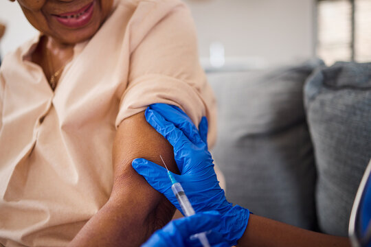 Hands, nurse and syringe for arm vaccine, medical and healthcare treatment for virus safety, flu and home wellness. Patient, doctor and woman with injection needle for medicine, covid and vitamin