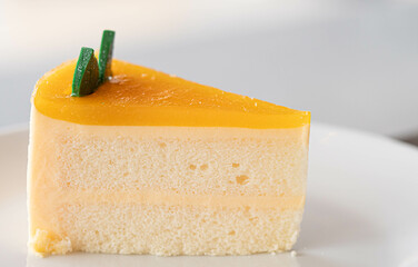 Triangular orange cake in a white plate