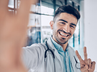 Happy, selfie and man doctor peace sign for social media for healthcare, medical and hospital work....