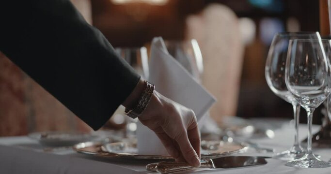 Woman carefully setting an upscale table