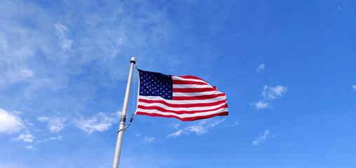 US Flag against blue sky