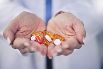 Woman, pharmacist and palm hands with pills for cure, pain relief or medication at pharmacy store. Closeup of female person, medical or healthcare professional with tablets, drugs or pharmaceuticals