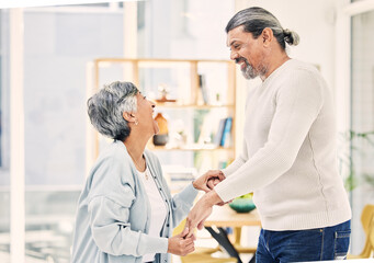 Obraz premium Happy, holding hands or old couple dancing in living room for love, care or joy bonding together at home. Smile, elderly man or senior woman in celebration for anniversary or romance in retirement