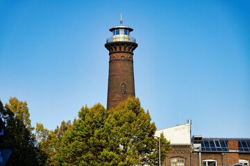 the historic Helios lighthouse in Cologne Ehrenfeld in autumn mood against clear sky