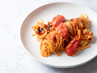Tomato and cuttlefish pasta on a plate	