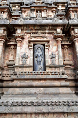Statue of Hindu God in stone relief Temple wall at Airavatesvara Temple, Darasuram, Kumbakonam, Tamilnadu.