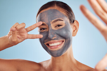 Woman, face mask and selfie in charcoal skincare and facial profile picture on studio blue...