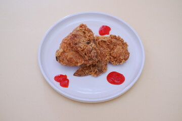 Crispy fried chicken on a plate with sauce, stock photo
