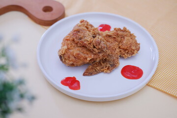 Crispy fried chicken on a plate with sauce, stock photo