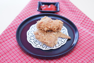 Fototapeta na wymiar Crispy fried chicken on a plate with sauce, stock photo