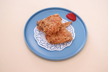 Crispy fried chicken on a plate with sauce, stock photo