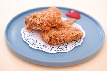 Crispy fried chicken on a plate with sauce, stock photo