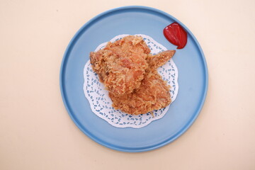 Crispy fried chicken on a plate with sauce, stock photo