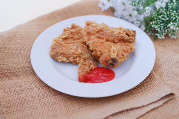 Crispy fried chicken on a plate with sauce, stock photo