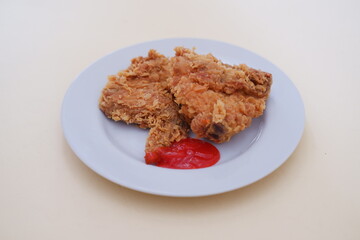 Crispy fried chicken on a plate with sauce, stock photo