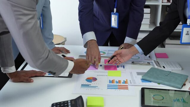Team of creative businesspeople  plan strategic analysis and brainstorm with financial reports, tax documents, calculations, analyze marketing processes with laptops in the office.