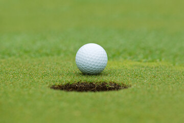 A golf ball and hole