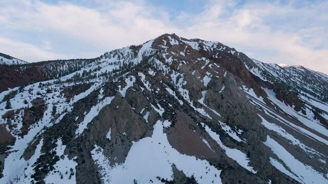 Cinematic aerial shot of snow covered Sierra Nevada mountains in California, USA