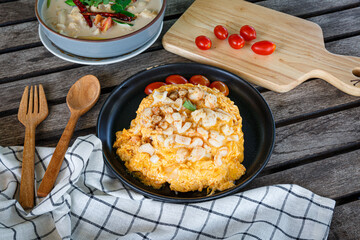 Crab omelette over rice, The fluffy omelette with chunks of fresh crab meat is placed on a mound of steamed rice.