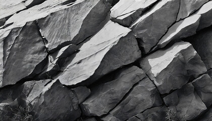 abstract, dark textured background with shades of grey, black, and white resembling a rugged mountain surface, conveying strength and resilience in its raw, natural beauty