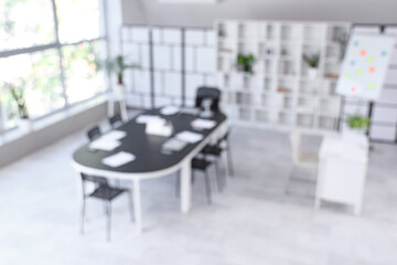 Blurred view of conference hall with table in office